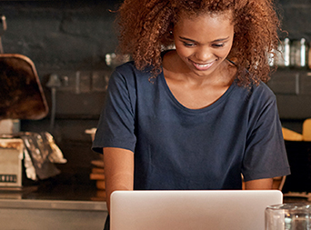 smiling female small business owner checking energy use